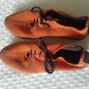 Arcopedico orange knit shoes.